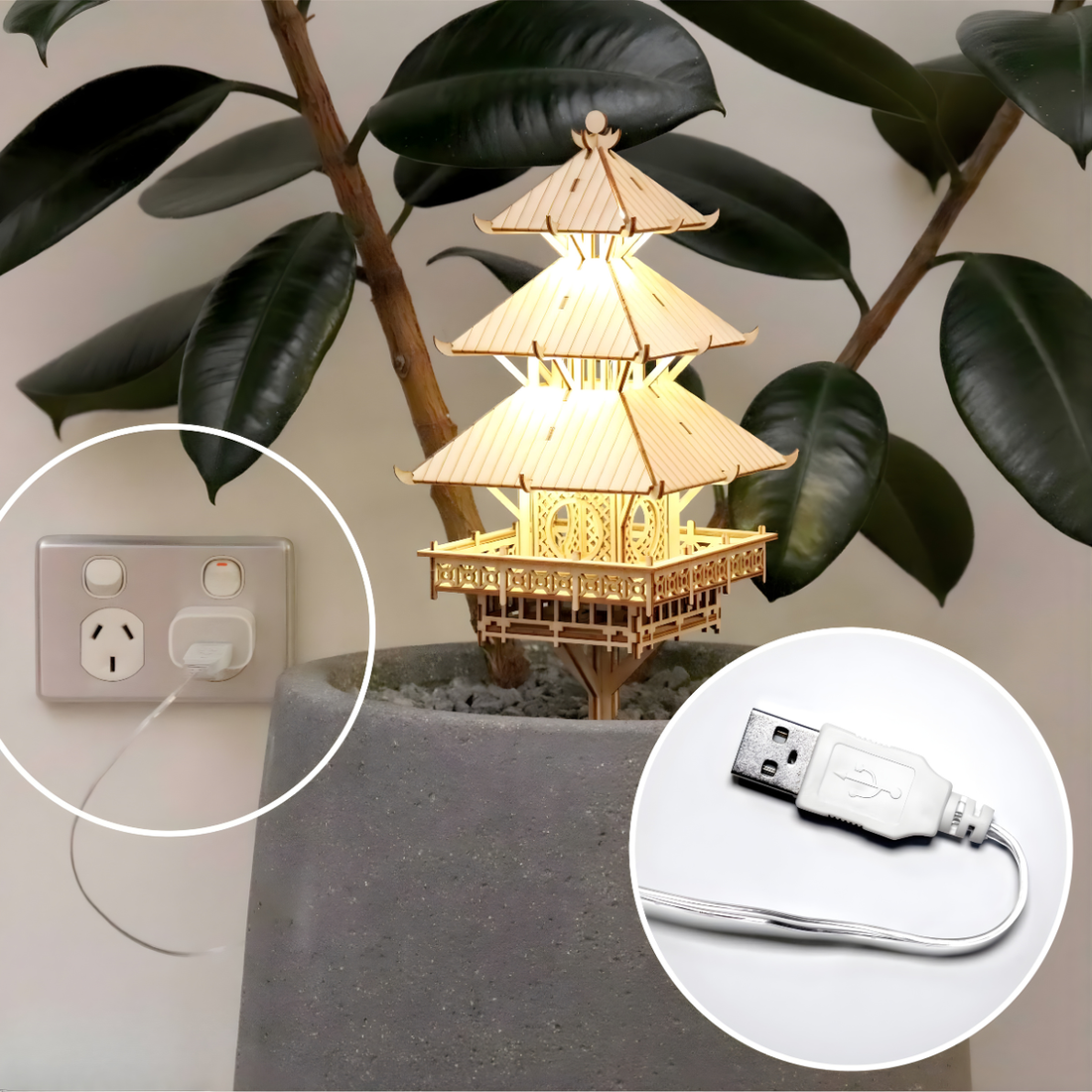 Decorative tiny treehouse pagoda with USB plug powered fairy lights placed in a rubber tree plant with leaves in the background.